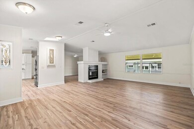 View From Front Door Entry into Living Room with Double Sided Wood Burning Fireplace 17.5x25