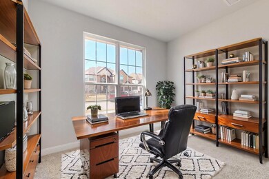 Office with baseboards and light colored carpet