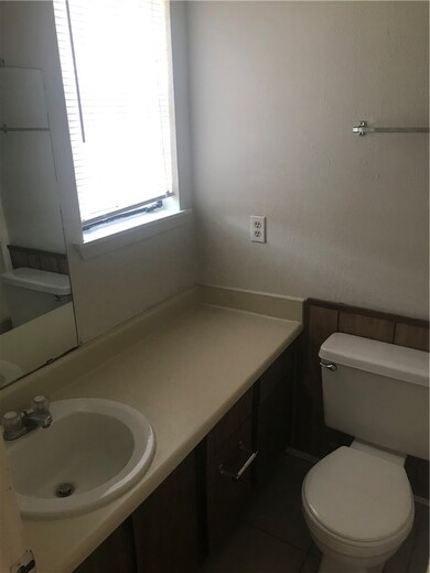 Bathroom featuring tile patterned flooring, vanity