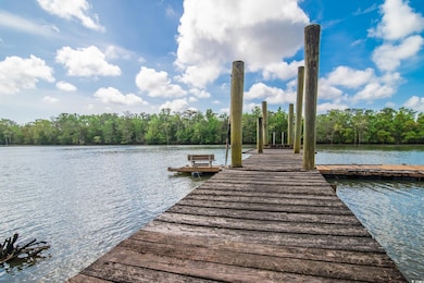 Dock area featuring a wooded view and a water view
