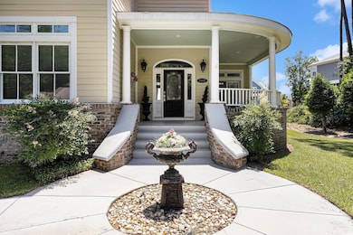 View of exterior entry with a porch and brick siding