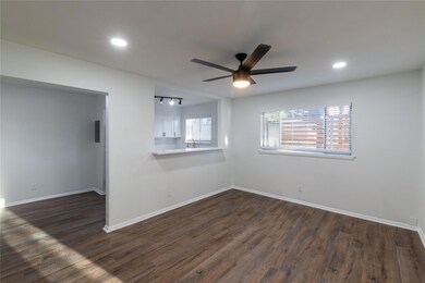 Empty room featuring ceiling fan, sink, and dark w