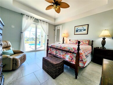 Master Bedroom with tray ceiling, ceiling fan, & s