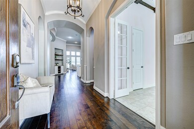 Inviting entrance with a warm, hardwood floor lead