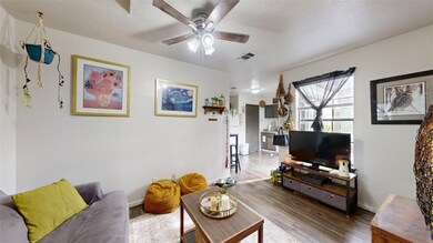 Living area with baseboards, dark wood-type floori