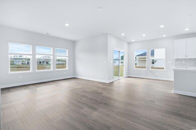 Unfurnished living room featuring wood finished floors and recessed lighting