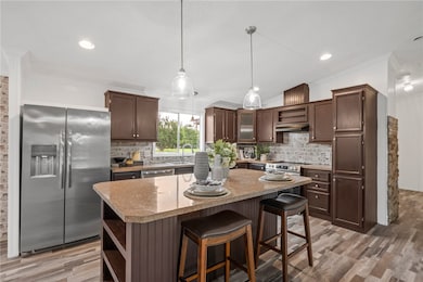 Kitchen featuring stainless steel appliances, open