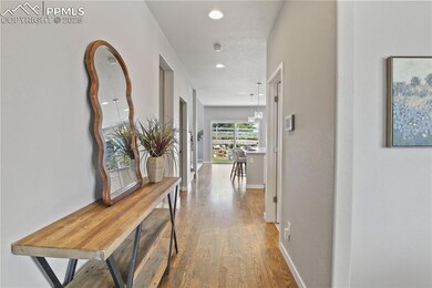 Hallway featuring wood finished floors, baseboards, and recessed lighting
