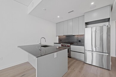 Kitchen featuring stainless steel appliances, lig