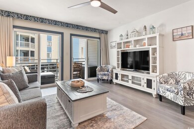 Living room with Mohawk RevWood flooring and ceiling fan.
