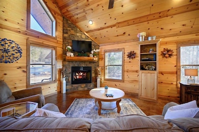 Living room with wood ceiling, a fireplace, and wo