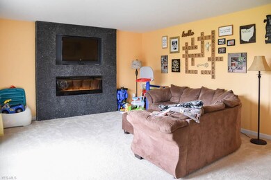 Spacious, sun-filled living room with an electric 