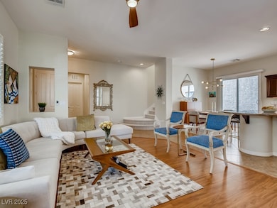 Living area with visible vents, a ceiling fan, rec