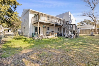 Rear view of house with a patio, a yard, and a wooden deck