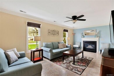 Spacious family room with ceiling fan, crown moldi