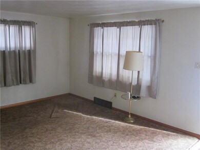 living room w/ large windows on each side. hardwoo