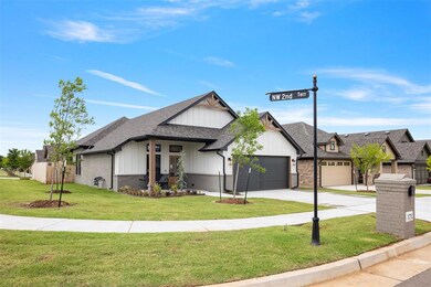 View of front of home with driveway, a garage, board and batten siding, a front yard, and brick siding