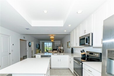Kitchen featuring stainless steel appliances, a peninsula, recessed lighting, a kitchen island, and light countertops