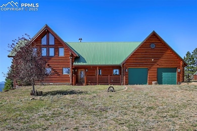 Log-style house featuring an attached garage, metal roof, and log exterior