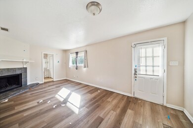 Unfurnished living room featuring a fireplace and hardwood / wood-style flooring