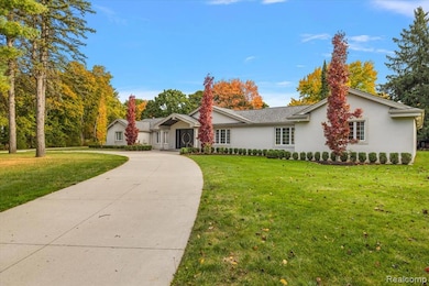 Ranch-style house with stucco siding and a front yard