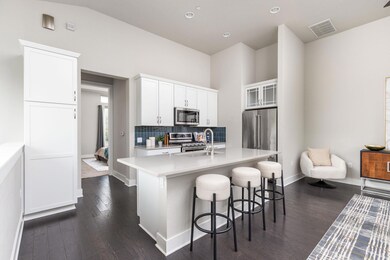 Kitchen with stainless steel appliances, baseboar