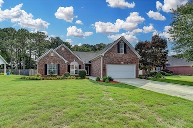 View of front of house with concrete driveway and brick siding