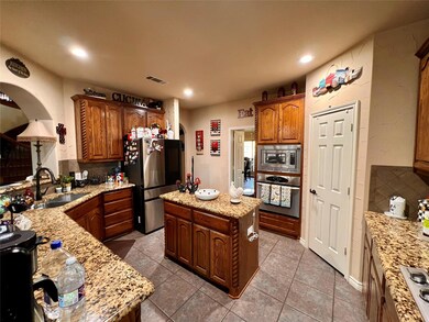 Kitchen with a sink, tasteful backsplash, applianc