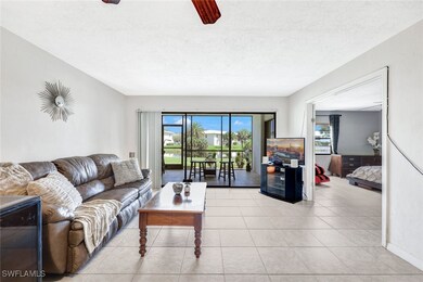 Tiled living room with ceiling fan and a textured