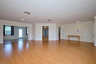 Unfurnished room featuring light wood-style floors, crown molding, baseboards, and recessed lighting