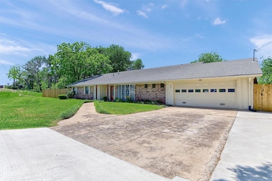 Ranch-style house with a garage and a front yard