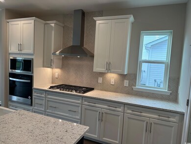 Kitchen featuring white cabinets, stainless steel 