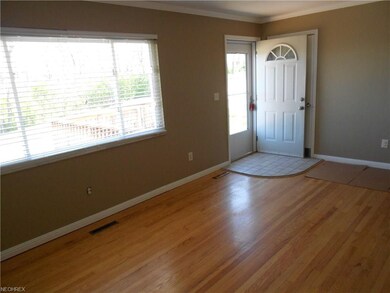 Entrance of front door to large living room area. 