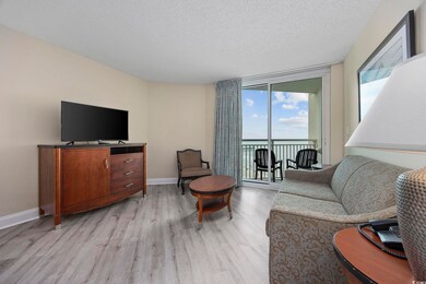 Living room with expansive windows, a textured cei