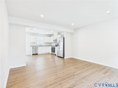 Unfurnished living room featuring light wood finished floors and recessed lighting