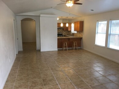 Spacious tiled living room, with arched entry way 