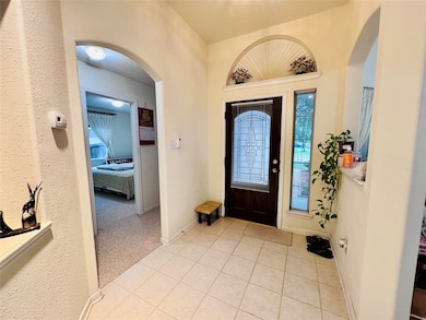 This entryway features a decorative front door wit