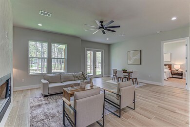Living area with ceiling fan, light wood finished