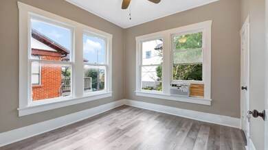 DEN FEATURES LOVELY HARDWOOD FLOORS