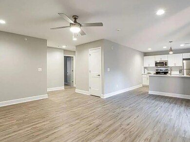 Unfurnished living room with ceiling fan and light