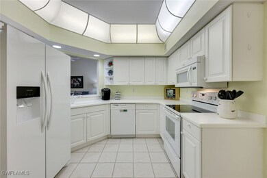 Kitchen with white appliances, light countertops,