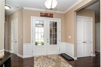 Inviting entry way with gorgeous hardwoods, custom molding, and natural light.
