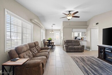 Living room featuring visible vents, baseboards, v