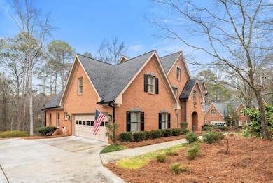 View of front of property featuring roof with shingles, concrete driveway, brick siding, and an attached garage