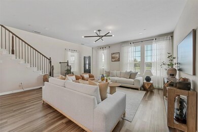 Living room with a notable chandelier and hardwood / wood-style flooring
