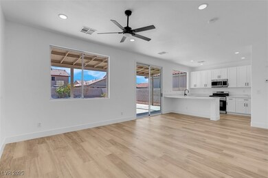 Unfurnished living room featuring ceiling fan, lig
