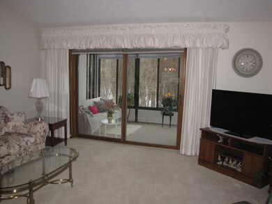 Living room with slider to 3 season room