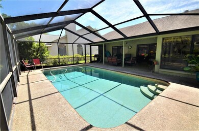 The screened pool area has a covered lanai area th