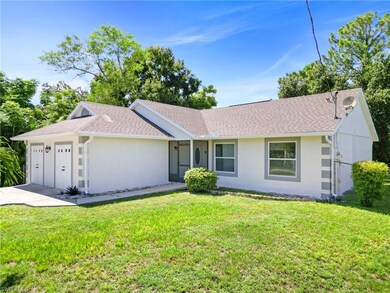 Ranch-style home with a front lawn and a garage
