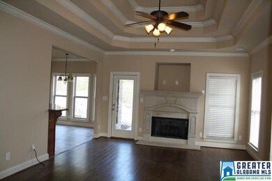 Greatroom with gas logs in fireplace. Trey ceiling